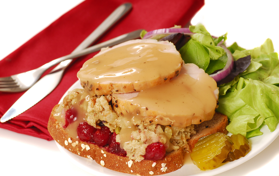 Open faced turkey sandwich with dressing and cranberry sauce